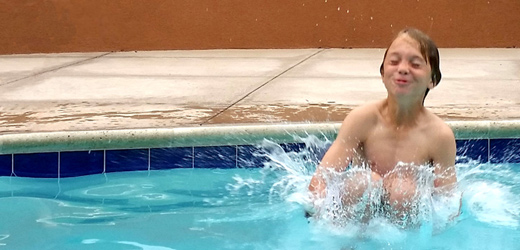 child jumping in pool